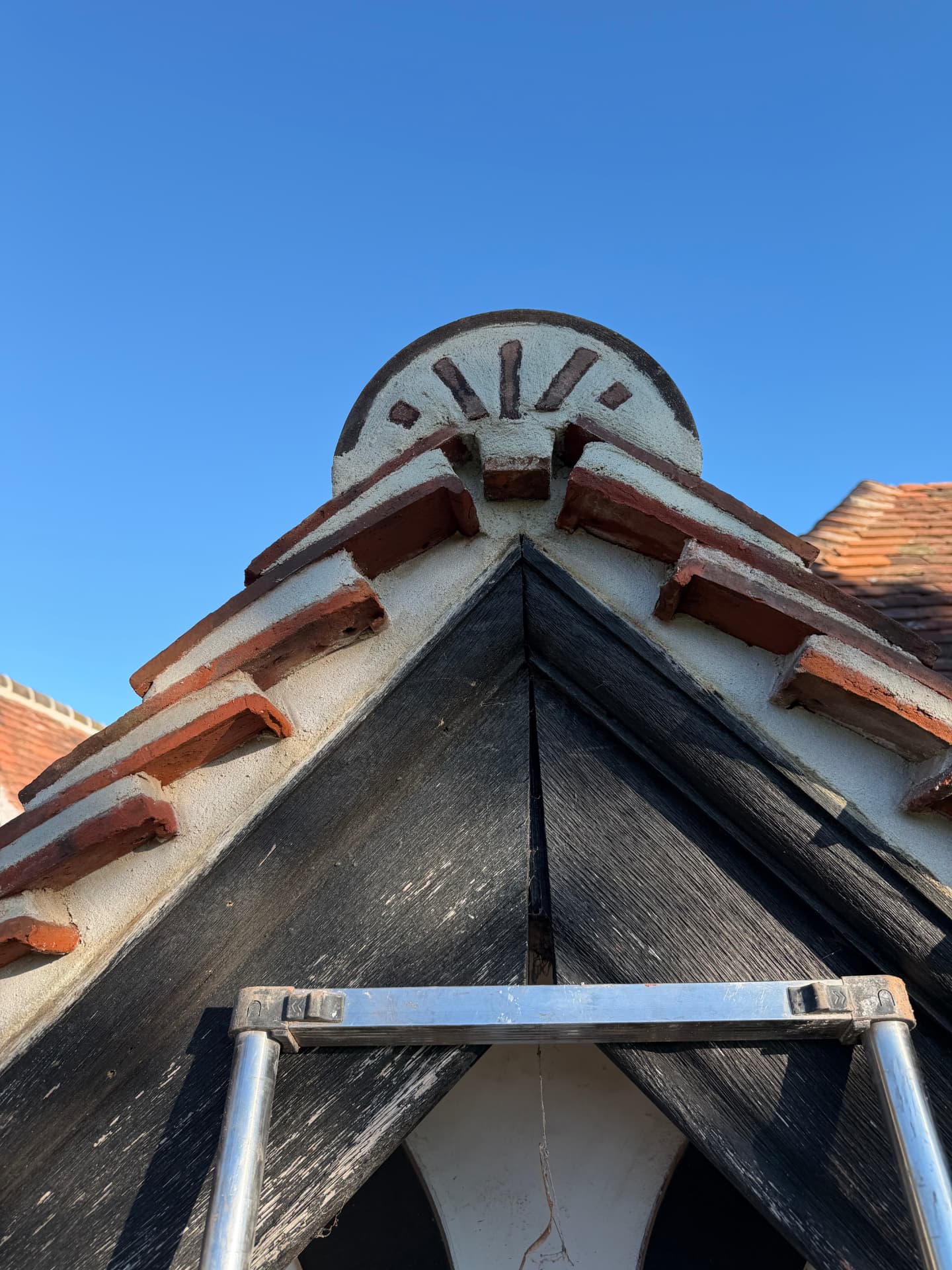Restored gable apex with brick and rendered detailing
